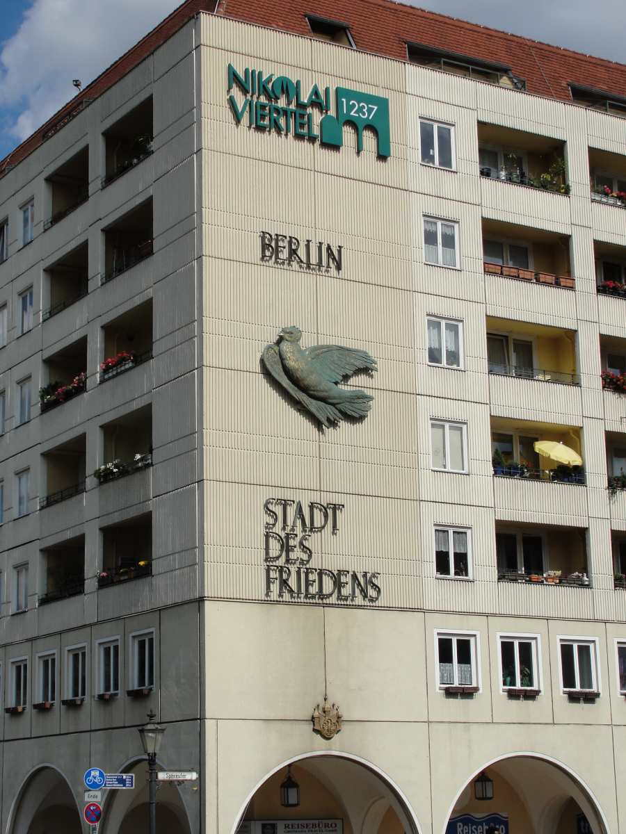 House wall entrance Nikolaiviertel Berlin-Mitte with peace dove and inscription »Berlin – City of Peace«